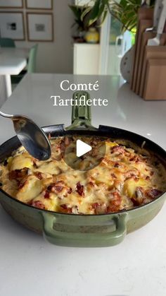 a casserole dish is shown with a spoon in it and the words, conte tartiflette