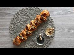 an appetizer is served on a plate with dipping sauces and bread croissants