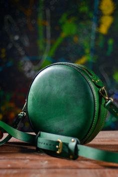 Green leather crossbody bag for women is a sophisticated accessory for everyday use, mini shoulder bag is the perfect size to carry. Circle shape gives this handbag special look. The item is created with attention to the smallest details, its simple and stylish. Our accessories are handmade and unique - one of a kind. ✦ Leather world - Genuine Leather shop Form Grosh Workshop ✦ Leather bags, wallets and accessories - these are tiny list that our workshop offers to you . Classic Everyday Bag With Round Case, Classic Everyday Bag With Round Case Shape, Classic Round Case Bag For Everyday Use, Leather Bags With Round Handle For Gifts, Classic Round Case Bag For Daily Use, Classic Round Case Bags For Daily Use, Round Bags As Gift, Green Leather Shoulder Bag With Round Handle, Elegant Leather Round Case Bag