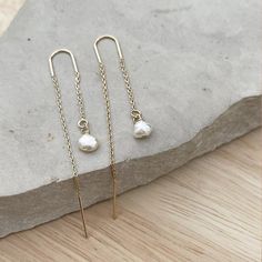 Minimalist Pearl Ear threader earrings, these dainty chain earrings with the perfect touch of femininity and it's great to combine with other earrings or wear alone for a minimalist look.Fun and delicate, these 14k gold-filled threader earrings come with wire bar ends on one side to make it easy to thread the chain through any pierced hole in your ear and on the other side, a small freshwater pearl. Mix and match with other HLcollection earrings for an edgy style statement or wear it on its own Delicate 14k Gold Filled Threader Earrings, Yellow Gold 14k Gold Filled Threader Drop Earrings, Dainty 14k Gold Ear Climbers, Delicate Dangle Linear Earrings With Chain, Hypoallergenic Yellow Gold Threader Drop Earrings, Single 14k Gold Filled Threader Earring As Gift, Delicate Dangle Linear Earrings, 14k Gold Filled Single Threader Earring Gift, 14k Gold Filled Long Drop Linear Earrings