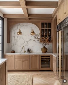 a large kitchen with marble counter tops and wooden cabinetry, along with an area rug on the floor