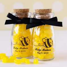 two jars filled with yellow candies next to each other