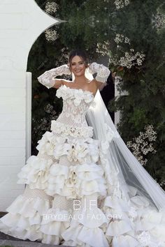 a woman in a wedding dress standing outside