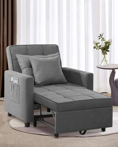 a gray chair and ottoman in a living room