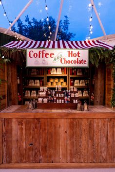 a coffee and hot chocolate stand is set up for customers to enjoy the evening outside