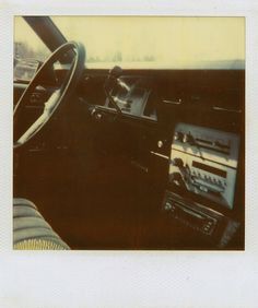 an old photo of a car dashboard and radio