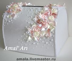 a white purse with pink flowers and pearls