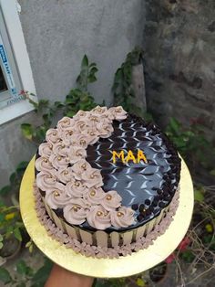 a chocolate cake with pink frosting and the word ma on it