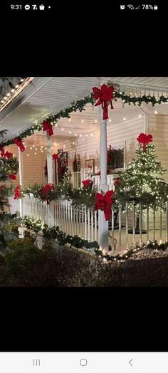 a house decorated for christmas with red bows and lights