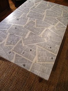 a table that has been made out of newspaper on top of carpeted flooring