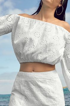 Embrace boho vibes with our Floral Eyelet Off-Shoulder Top. The charming floral eyelets and off-shoulder design make it perfect for breezy, carefree days. Product code: CAA04B4E060CC Features:  Woven Off-shoulder styling Long peasant sleeves Bubble hem Elasticized trim Material: 100%COTTON. White Off-shoulder Summer Top For Vacation, Spring Off-shoulder Top For Day Out, Spring Summer Off-shoulder Top, Summer Cold Shoulder Off-shoulder Top For Day Out, Bohemian Eyelet Top For Spring, Spring Bohemian Eyelet Top, Bohemian Off-shoulder Top For Beach, Summer Off-shoulder Top For Brunch, Bohemian Summer Eyelet Tops