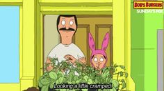 a man and woman wearing bunny ears standing in front of a door with plants growing out of it