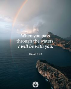 a rainbow in the sky over water with a bible verse written on it that reads, when you pass through the waters, i will be with you