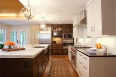 a kitchen with an island, stove and sink in it's center area is shown