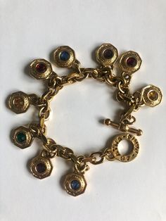 Superb large vintage golden bracelet from the French brand Agatha Paris. This very pretty bracelet has golden and multi-colored charms and closes with a toggle clasp on which Agatha Paris is written. This pretty bracelet will be sent to you quickly in an Agatha bag (ready to be offered. Do not hesitate to contact me if you have any questions. I have many Agatha jewelry pieces in my shop: https://rosethalievintage.etsy.com/ Thank you for your visit. Beautiful big golden colored and colorful vinta Paris Charm Bracelet, Big Bracelets, Golden Bracelet, Vintage Charm Bracelet, Vintage Bracelet, Pretty Bracelets, Bracelet Vintage, Vintage Bracelets, Toggle Clasp