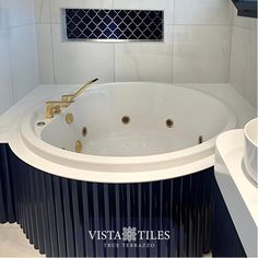 a large white bath tub sitting inside of a bathroom