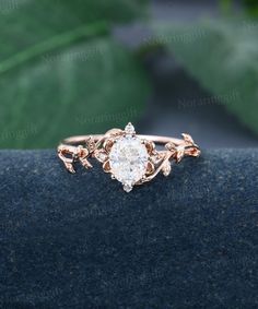 a close up view of a diamond ring with leaves on it