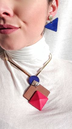 This Leather Choker Necklace is inspired by a Multi Color Bauhaus style. The modern 3D Red abstract pendant design is elegantly suspended by an adaptable 24k gold open collar neck cuff. Modern Red Necklace For Party, Modern Red Metal Jewelry, Bold Geometric Jewelry For Gifts, Modern Red Geometric Jewelry, Bauhaus Jewelry, Architectural Jewelry, Abstract Pendant, Leather Choker Necklace, Contemporary Necklace