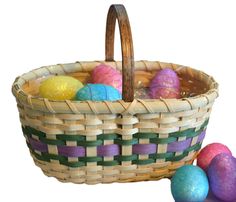 a basket filled with lots of colorful easter eggs