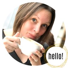 a woman holding a coffee cup in her right hand and looking at the camera with an hello sign on it