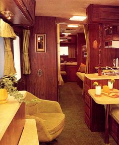 the interior of a train car with wood paneling and yellow chairs in front of it