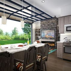 a kitchen with an island, stove and dining table in front of a large window