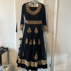 Gorgeous Black And Gold Work. Worn Once Just Like New! Long And Flowy Dress Fitted Black Dress For Festivals, Elegant Long Sleeve Anarkali Set For Celebration, Black Anarkali Salwar Kameez With Long Sleeves, Black Zari Work Dress For Celebrations, Black Anarkali Set For Celebration, Black Semi-stitched Dress For Celebration, Fitted Black Anarkali Set For Celebration, Elegant Long Sleeve Maxi Dress For Festivals, Formal Black Anarkali Set For Festivals