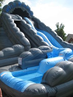 an inflatable water slide with blue and grey colors is shown at the bottom