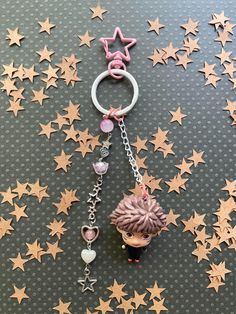 a keychain with a cupcake and stars on the floor next to it