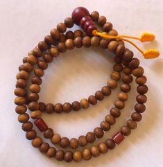 This small sandal wood mala has three traditional decoration beads and guru beads. It is from Nepal and nice and beautiful mala. it is 11 inches long mala. Holistic Wooden Beads Mala For Rituals, Holistic Wooden Mala For Rituals, Traditional Wooden Beaded Bracelets For Meditation, Traditional Wooden Beaded Bracelets, Spiritual Wooden Beads Rosary For Meditation, Spiritual Rosary With Wooden Beads For Meditation, Traditional Wooden Bracelets With Round Beads, Traditional Wooden Bracelet With Round Beads, Brown Mala With 8mm Beads For Puja