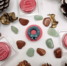 several different types of chocolates and decorations on a white table with pineconis