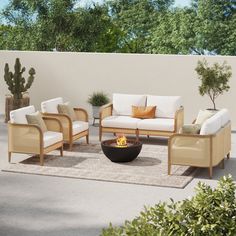 a living room with furniture and a fire pit in the middle of an outdoor area