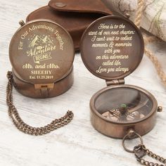 two personalized pocket watches sitting on top of a table