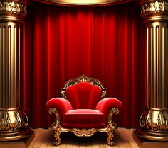 a red chair sitting on top of a wooden floor in front of a red curtain