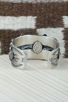 This sterling silver bracelet was made by Navajo silversmith Andrew Gordon. The inside is signed G and stamped sterling.Size: 5 3/8" (will fit up to a 6 3/8" wrist)Gap: 1 1/8"Width: 1 1/2"Free shipping on all orders! We ship with USPS and always include tracking. All orders ship within a day of payment.Returns are accepted up to 30 days after you receive your order. Just send us a message. Our shop offers cash back or store credit. The item must be returned in new condition. Southwestern Silver Cuff Bracelet, Southwestern Silver Bracelets With Concho, Silver Artisan Bracelet, Western Sterling Silver Cuff Bracelet With Concho, Silver Southwestern Stamped Cuff Bracelet, Southwestern Sterling Silver Stamped Bangle Bracelet, Southwestern Style Stamped Sterling Silver Bangle Bracelet, Southwestern Silver Stamped Cuff Bracelet, Western Silver Cuff Bracelet With Concho