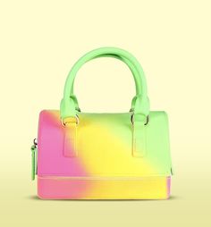 This vibrant jelly handbag is a playful blend of colors, that instantly catch the eye. Its compact yet spacious design makes it perfect for carrying your daily essentials, while the durable jelly material ensures it's both stylish and easy to clean. The sturdy handles provide comfortable carrying, making it a fun and practical accessory for casual outings, festivals, or summer events. With its unique color combination and modern design, this handbag adds a pop of color and a touch of fun to any outfit. This handbag is more than just a stylish accessory; it's a practical addition to your wardrobe that blends fashion with functionality. Trendy Multicolor Shoulder Bag, Trendy Summer Satchel For School, Trendy Green Handheld Satchel, Trendy Green Double Handle Satchel, Trendy Multicolor Bag, Trendy Multicolor Bags, Trendy Multicolor Handheld Satchel, Trendy Plastic Tote Shoulder Bag, Green Summer Satchel With Detachable Handle