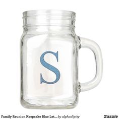 a glass mug with the letter s painted on it's front and bottom half