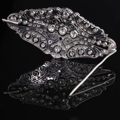 Stunning Art Deco Platinum & Diamond Brooch with beautiful delicate filigree work and milgraining. Item #JP-P0011 Metal: Platinum Weight: 17.3 Grams Diamond Weight: Approximately 4 cts of old european cut & rose cut diamonds Diamond Color: I Diamond Clarity: SI2 Measurements: 33 x 70 mm Layaway: For your convenience, we will be happy to provide layaway payment options. Please contact us to work out a layaway plan which best suits your needs. All layaway purchases are final sale. All dome Ornate Diamond Brooch For Formal Occasions, Ornate Diamond Brooch For Formal Wear, Ornate Diamond Brooches For Formal Occasions, Elegant Filigree Brooches For Evening, Luxury Platinum Wedding Brooches, Formal Diamond Brooch With Intricate Design, Formal Diamond Brooches With Intricate Design, Elegant Engraved Brooches For Ceremonial Occasions, Ornate Diamond Brooch With Intricate Design