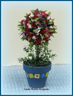 a potted plant with red, white and blue flowers