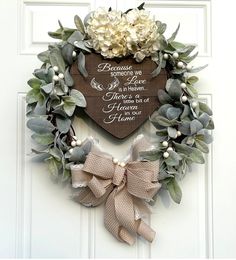 a heart shaped wreath hanging on the front door