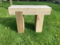 a wooden bench sitting on top of a lush green field