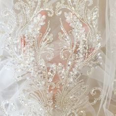 the back of a wedding dress with beading and sequins