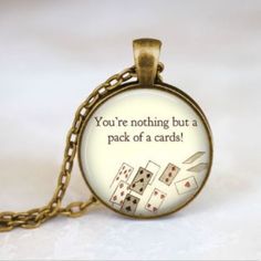 a necklace with a quote on it that says you're nothing but a pack of cards