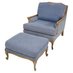 a blue chair and footstool sitting next to each other