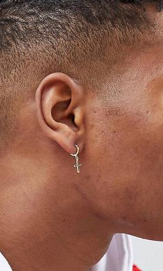 a close up of a person wearing a pair of ear piercings on their ears