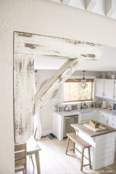 an open window in the middle of a kitchen with white cabinets and counter tops on either side