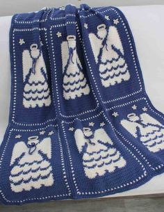 a crocheted afghan with blue and white designs