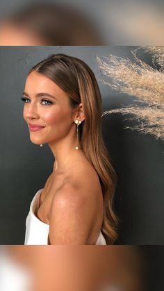 a woman with long hair wearing earrings