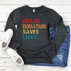 This long sleeve tee is a great gift for someone who has had a transplant and is a great way to help raise awareness of organ donation.  Soft and fashionable Bella Canvas 3501 long sleeve t-shirt. 👕Sizing: Sizes range from Small - 2XL * 100% combed and ring-spun cotton * Heather colors are 52% combed and ring-spun cotton, 48% polyester * Athletic Heather is 90% combed and ring-spun cotton, 10% polyester * Fabric weight: 4.2 oz/yd² (142.4 g/m²) * Regular fit * Side-seamed construction * Crew nec Pre-shrunk Long Sleeve T-shirt As A Gift, Long Sleeve Pre-shrunk T-shirt As Gift, Long Sleeve Screen Print T-shirt Gift, Long Sleeve Screen Print T-shirt As Gift, Long Sleeve Graphic Tee T-shirt As Gift, Relaxed Fit Long Sleeve T-shirt For Gift, Relaxed Fit Long Sleeve T-shirt As Gift, Long Sleeve T-shirt With Text Print For Gift, Text Print Long Sleeve T-shirt For Gifts