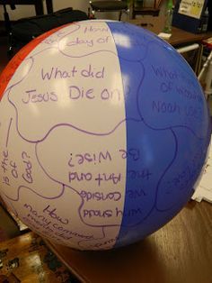 a large blue and white ball with writing on it sitting on a table in an office